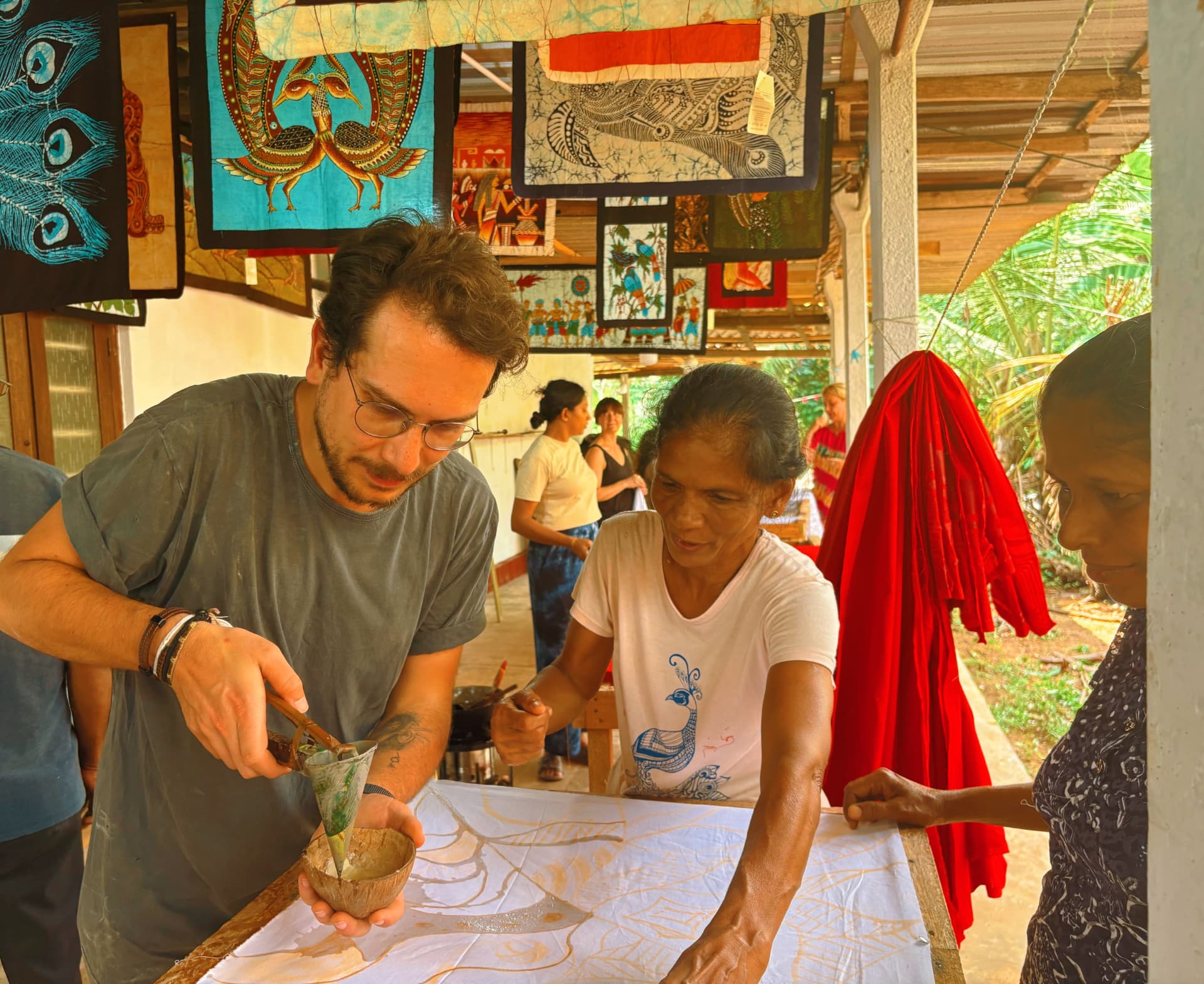 Gökhan learning traditional batik with local artisans in Sri Lanka