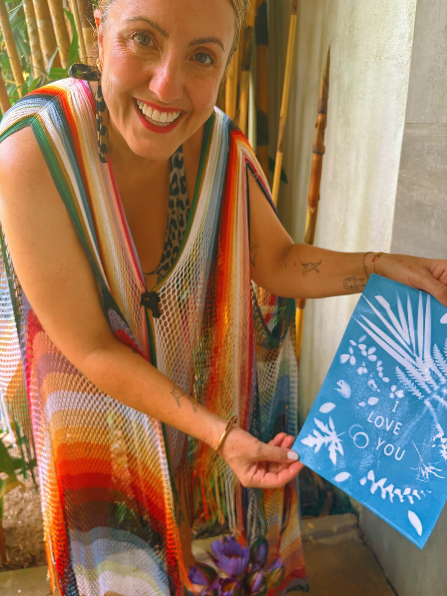 Anna's testimonial photo shows a guest smiling while holding a blue cyanotype print made on the retreat