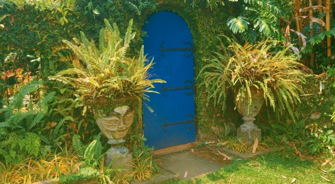 A vivid blue doorway in a Sri Lankan garden wall