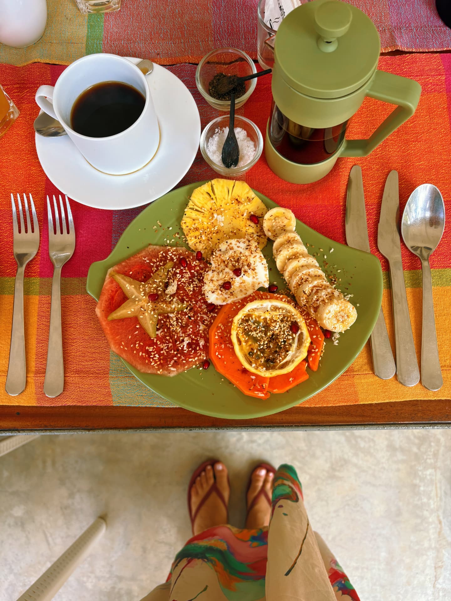 Tropical fruit breakfast plate with pineapple, papaya, banana and local coffee
